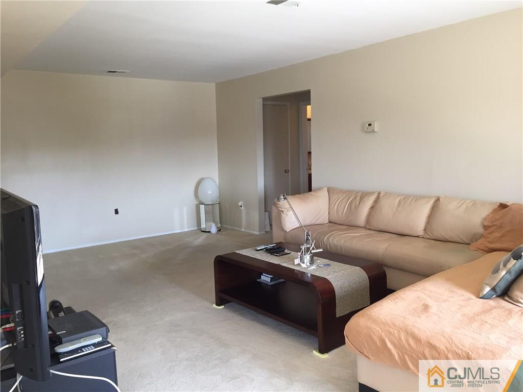 1623 Raspberry Court, Unit 1623 Edison, NJ 08817 - Photo 4 of 18 a living room with furniture and a flat screen tv