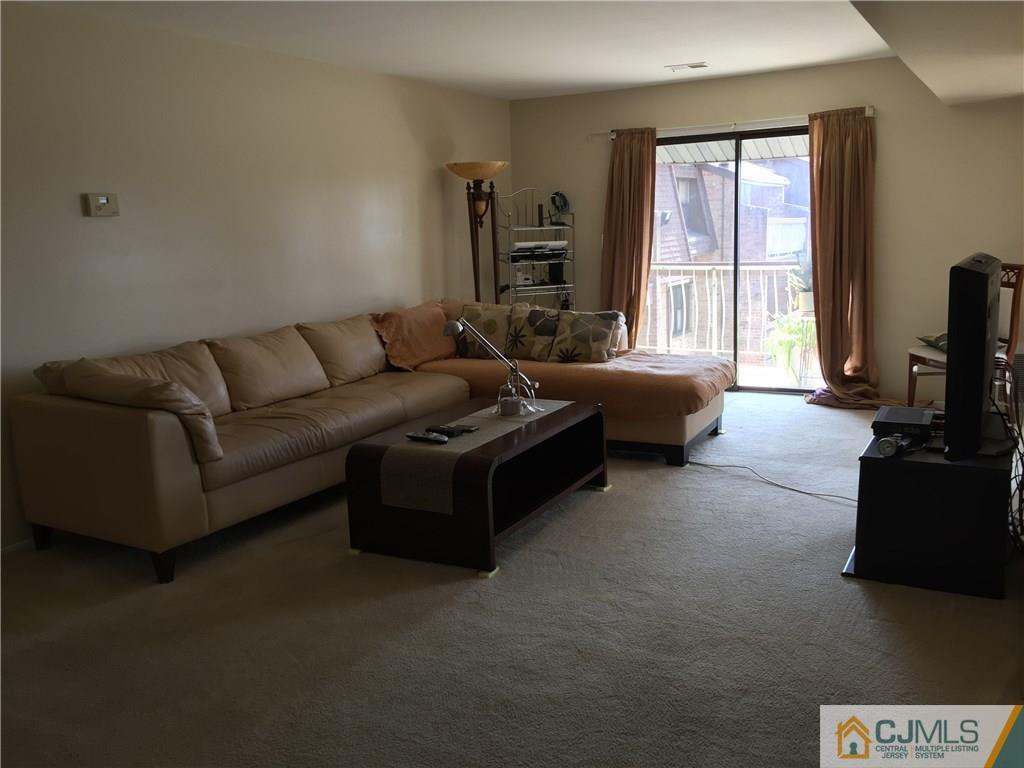 1623 Raspberry Court, Unit 1623 Edison, NJ 08817 - Photo 5 of 18 a living room with furniture and a flat screen tv