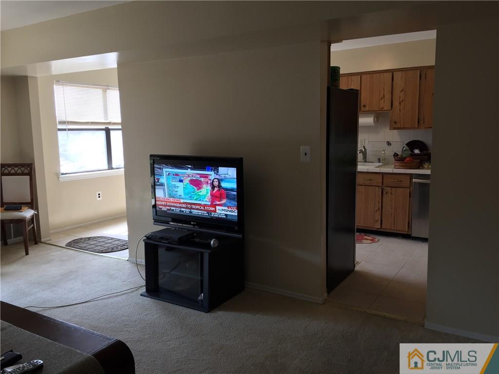 1623 Raspberry Court, Unit 1623 Edison, NJ 08817 - Photo 6 of 18 a living room with furniture and a flat screen tv