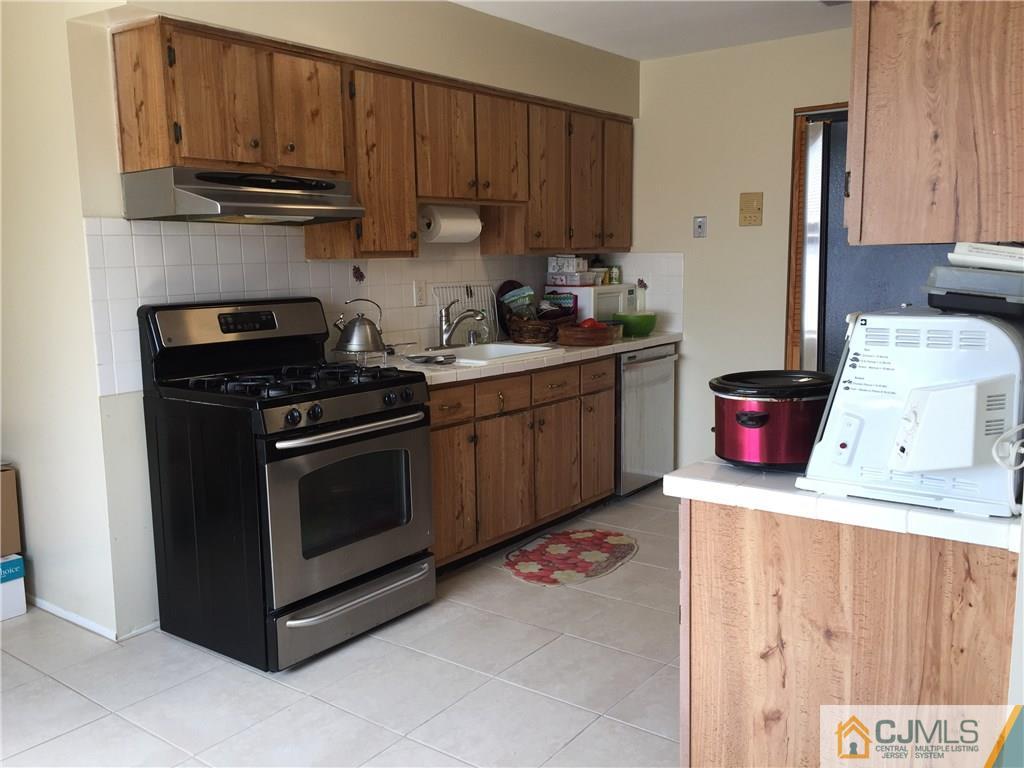 1623 Raspberry Court, Unit 1623 Edison, NJ 08817 - Photo 7 of 18 a kitchen with stainless steel appliances a stove and a cabinets