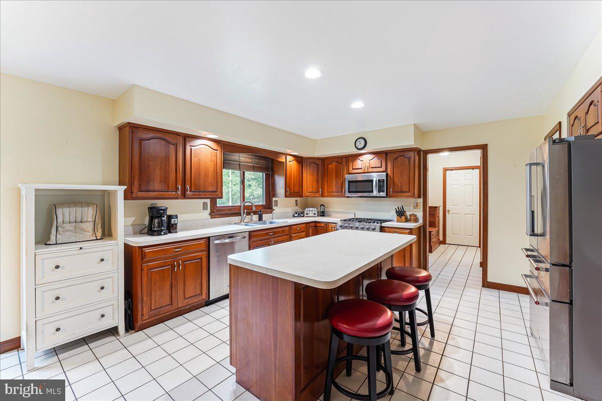 336 Howarth Road Media, PA 19063 - Photo 18 of 61 a large kitchen with stainless steel appliances kitchen island granite countertop a stove refrigerator and cabinets