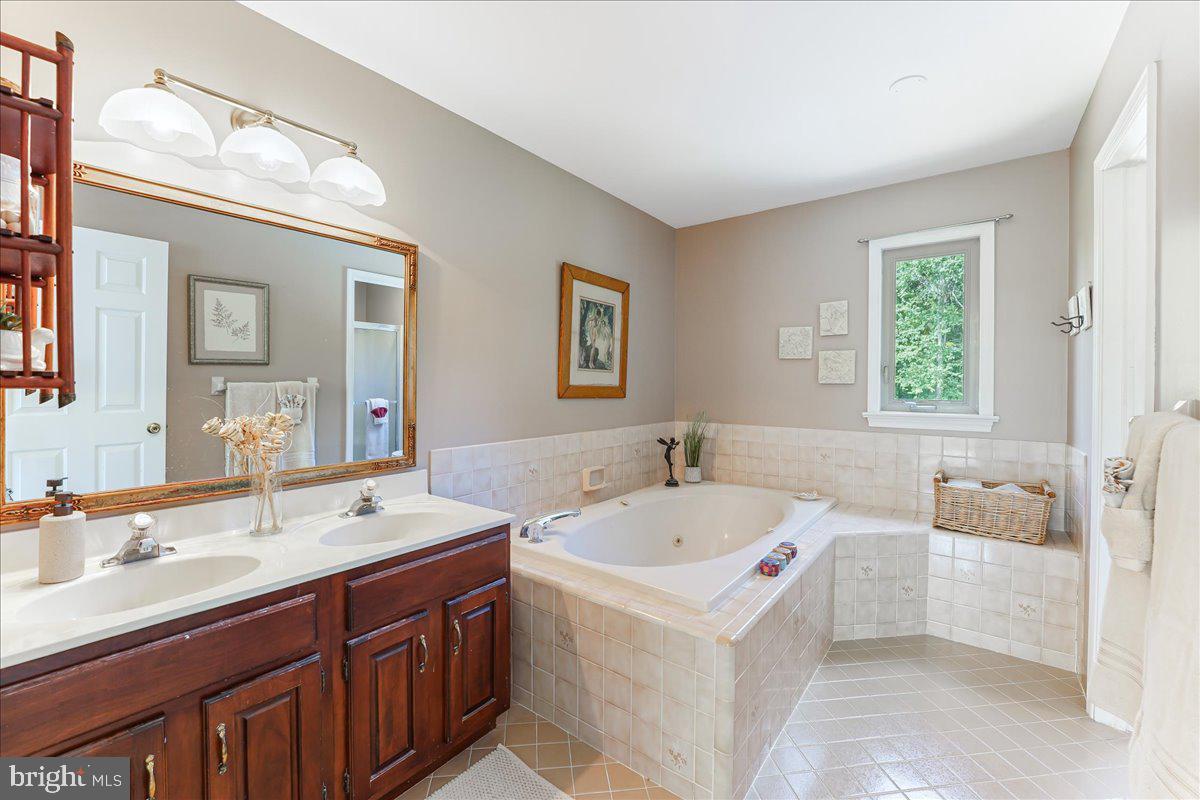 336 Howarth Road Media, PA 19063 - Photo 31 of 61 a bathroom with a sink double vanity granite tub and a mirror