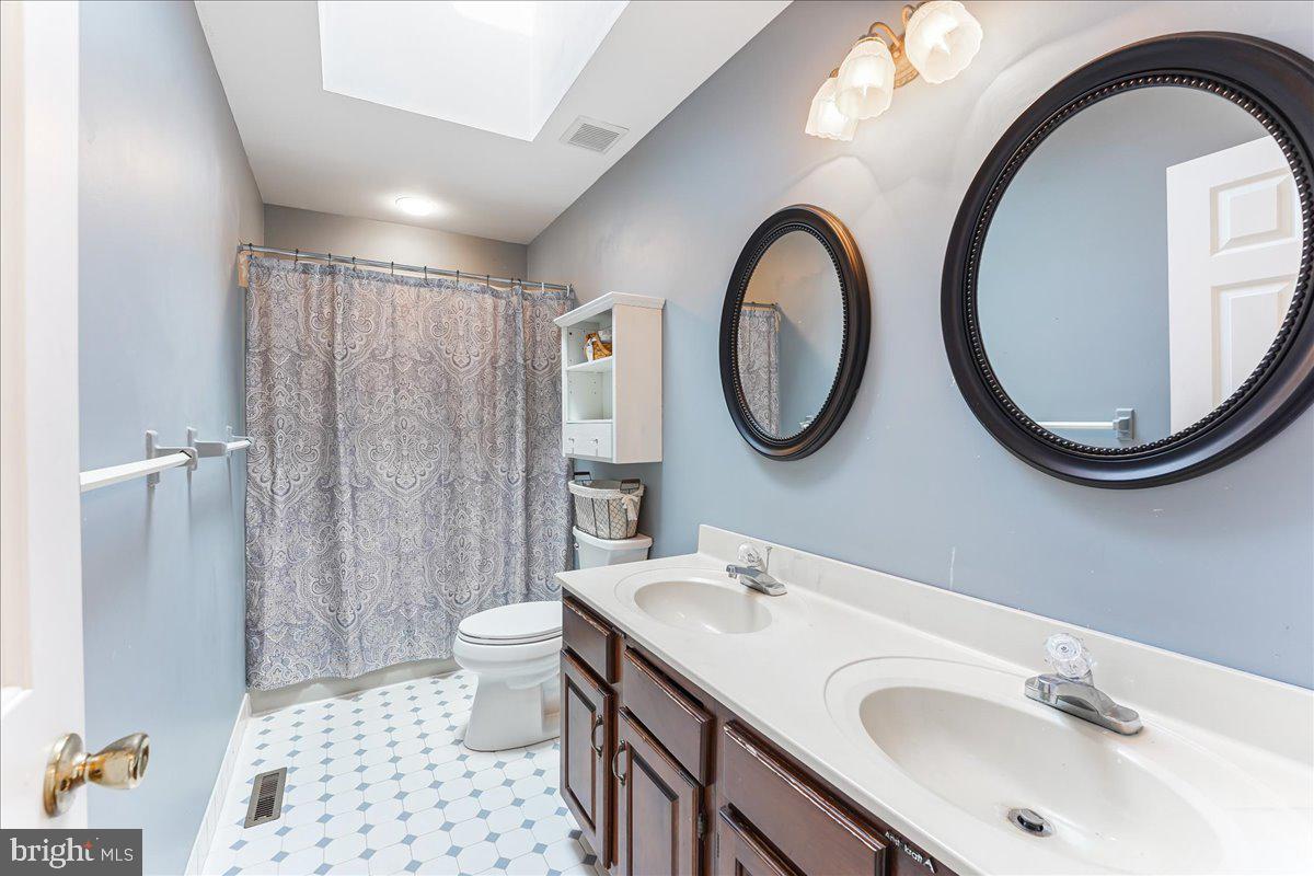 336 Howarth Road Media, PA 19063 - Photo 36 of 61 a bathroom with a sink a toilet and a mirror