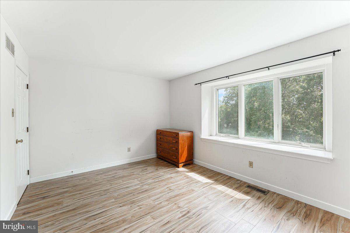 336 Howarth Road Media, PA 19063 - Photo 38 of 61 an empty room with wooden floor and windows