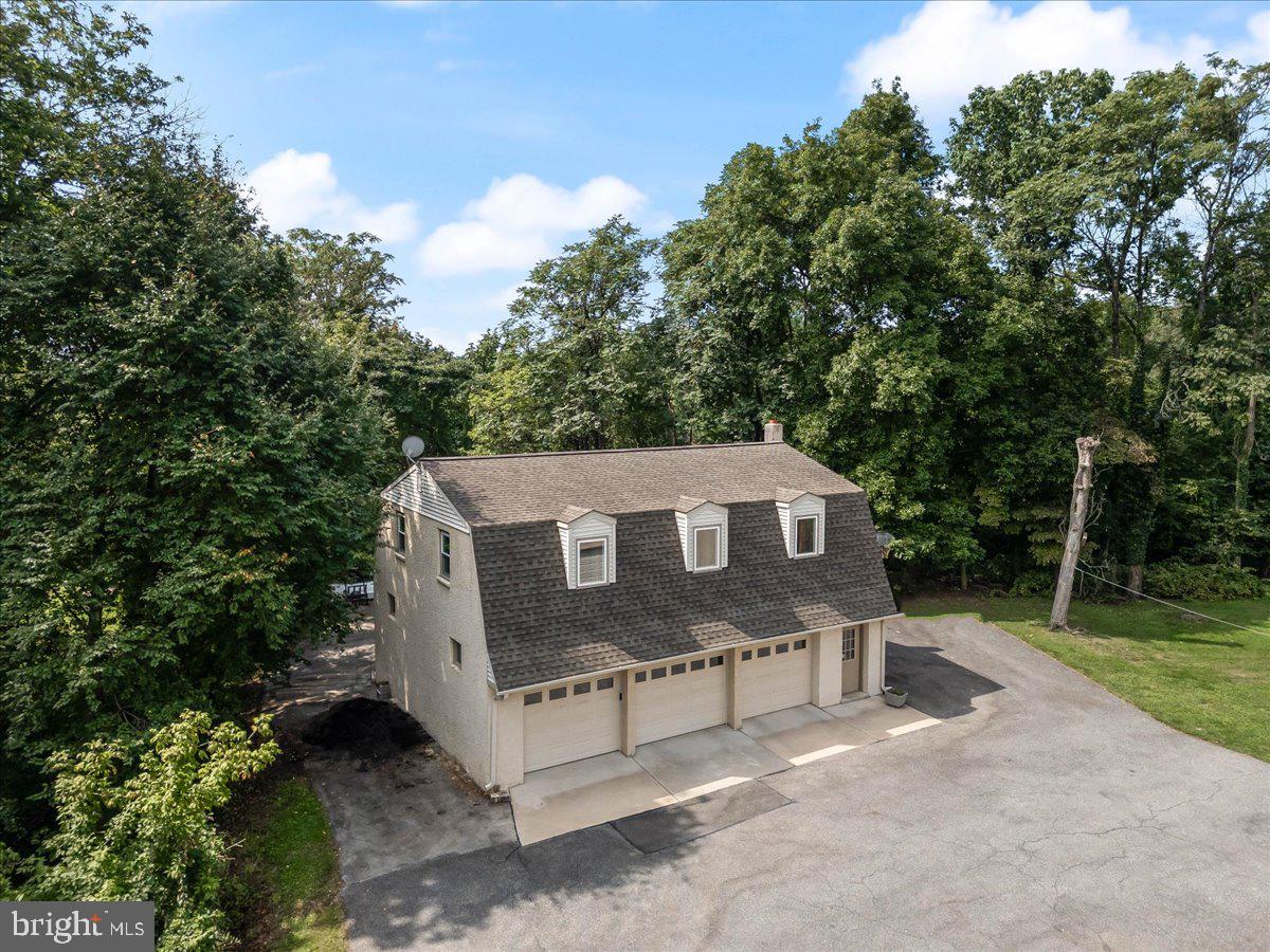 336 Howarth Road Media, PA 19063 - Photo 48 of 61 a view of a wooden house with a yard and large trees