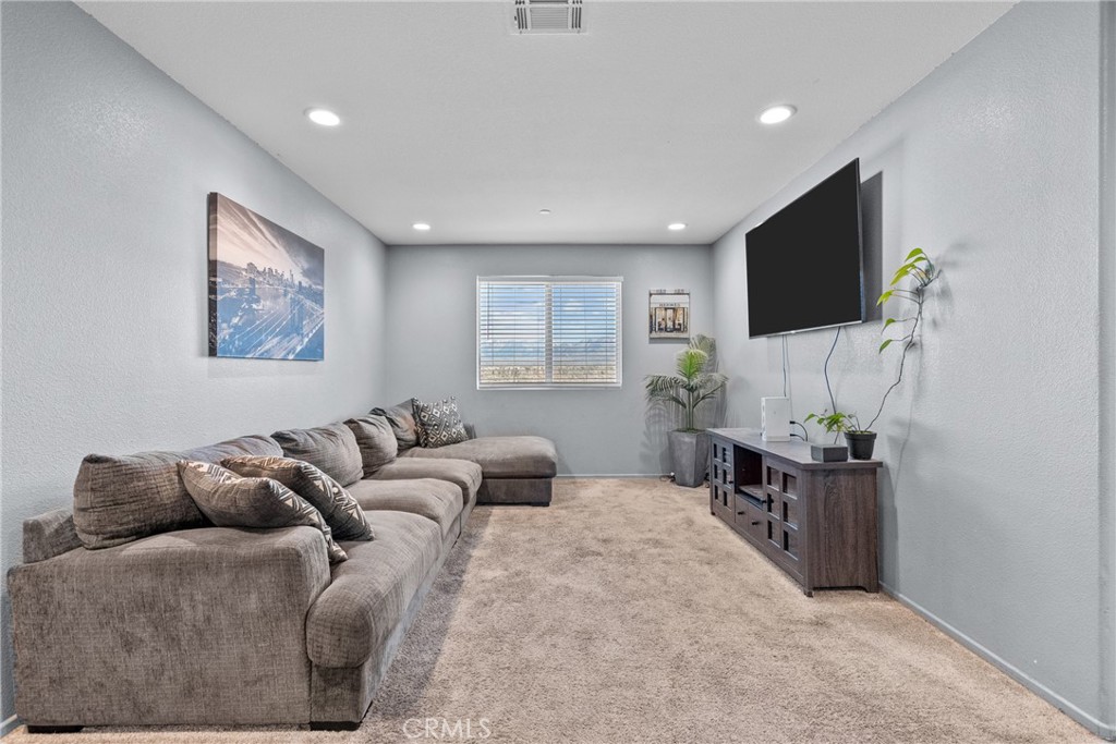 6949 Beale Road Palmdale, CA 93552 - Photo 15 of 32 a living room with furniture and a flat screen tv