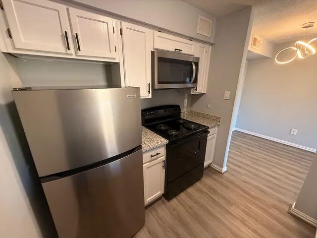 a kitchen with a refrigerator stove and microwave