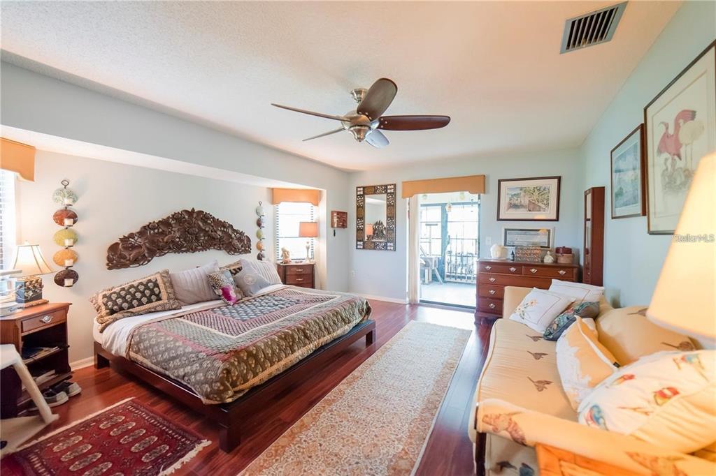 145 Bunker Road Rotonda West, FL 33947 - Photo 11 of 18 a bedroom with a large bed and a chandelier