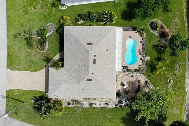 an aerial view of a house with a yard and sitting area