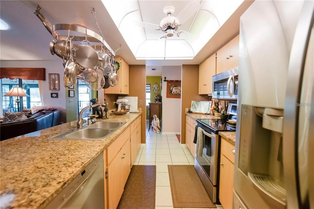 145 Bunker Road Rotonda West, FL 33947 - Photo 4 of 18 a large kitchen with lots of counter space and stainless steel appliances