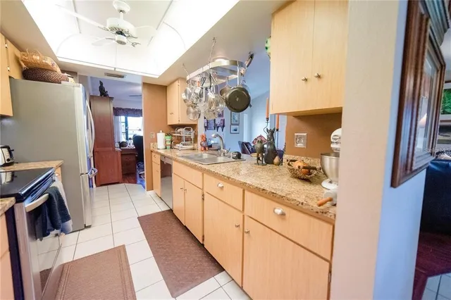 a large kitchen with a sink and washing machine