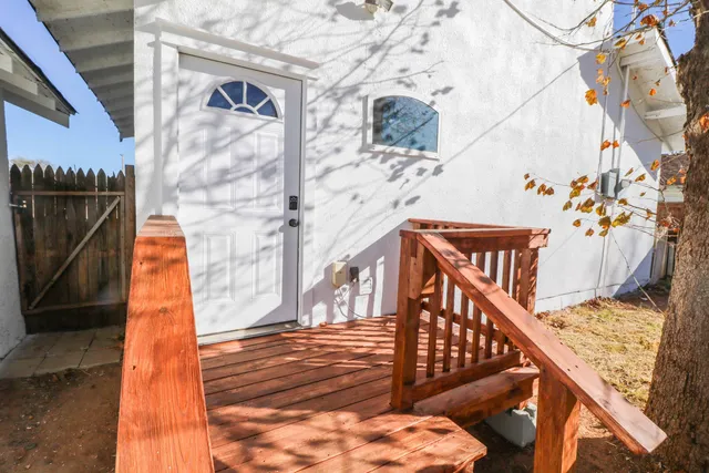 a view of balcony with wooden floor and seating space