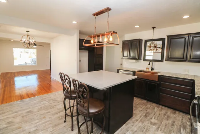 a kitchen with a kitchen island wooden cabinets and refrigerator
