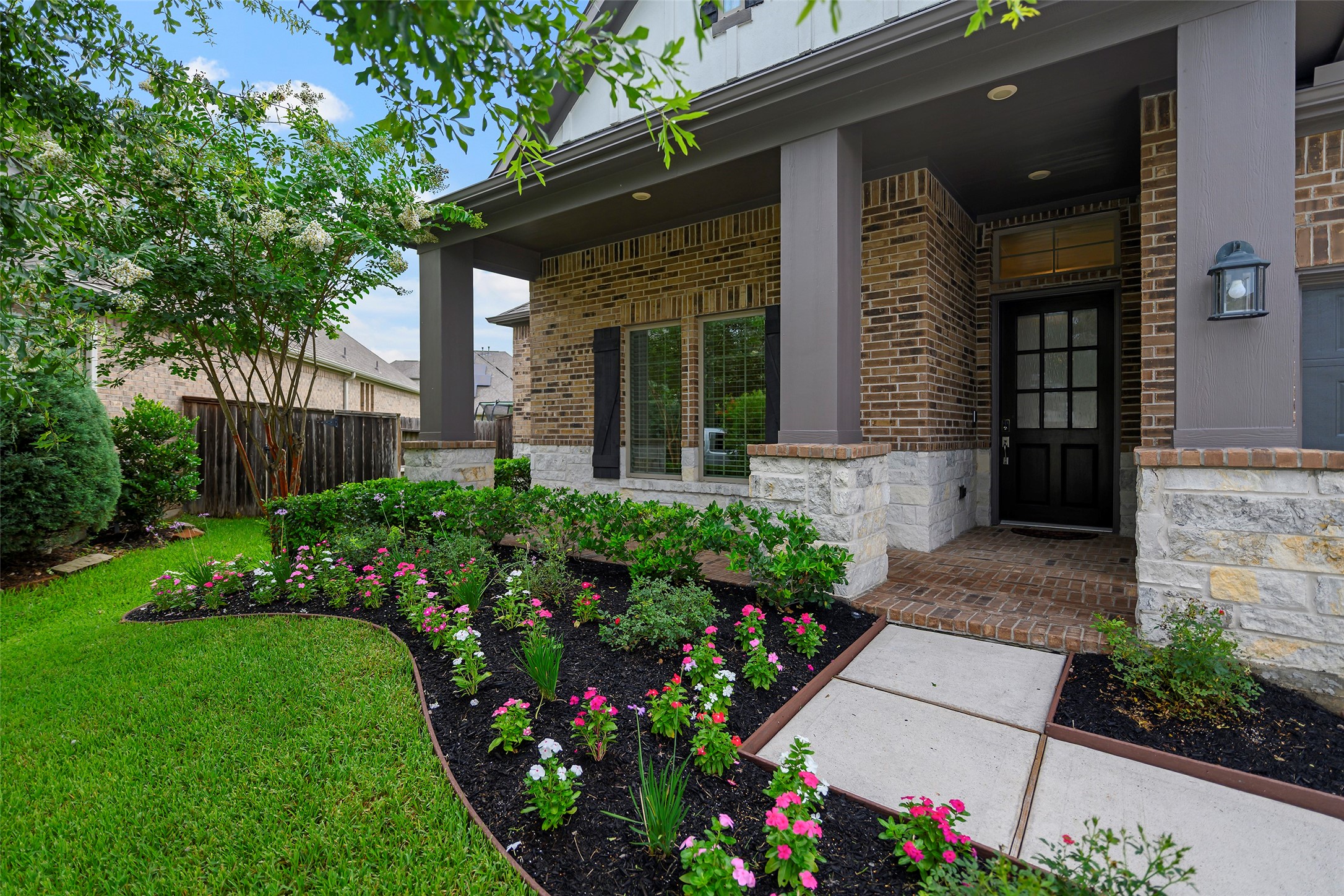 20330 Rosegold Way Spring, TX 77379 - Photo 7 of 48 Inviting covered front porch surrounded by manicured landscaping and colorful flower beds.