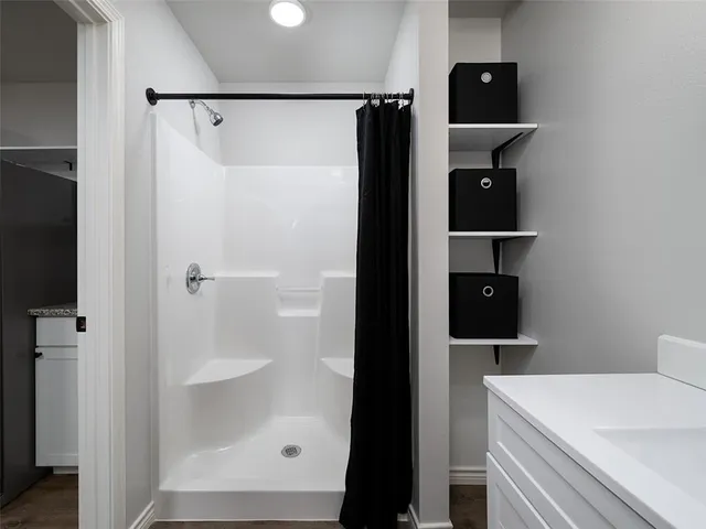 a bathroom with a toilet sink vanity and mirror
