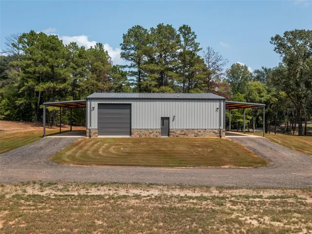 a view of a house with a backyard and a garage