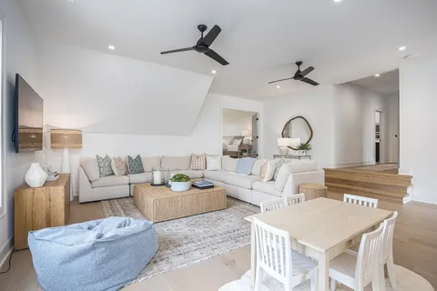 a living room with furniture and a painting on the wall