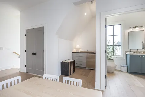 a bathroom with a toilet a sink a glass door a shower a mirror and vanity