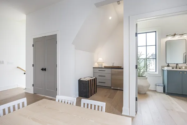 a bathroom with a toilet a sink a glass door a shower a mirror and vanity