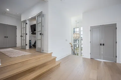 a living room with furniture a fireplace and a floor to ceiling window