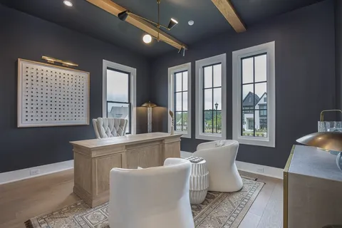 a kitchen with a table chairs stove and wooden floor