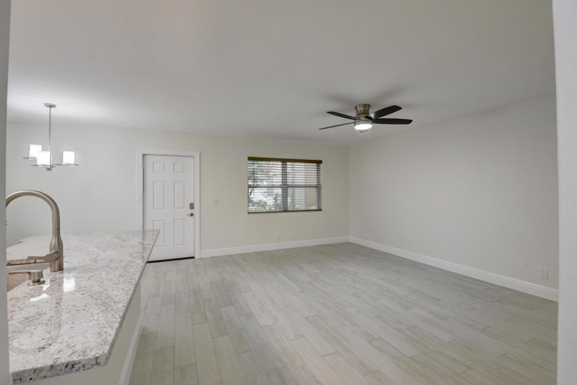 76 Flanders B Delray Beach, FL 33484 - Photo 2 of 35 an empty room with a ceiling fan and window