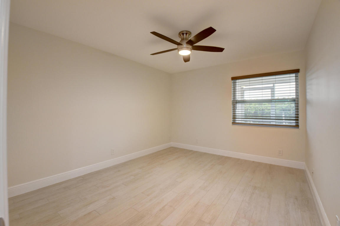 76 Flanders B Delray Beach, FL 33484 - Photo 12 of 35 an empty room with windows and fan