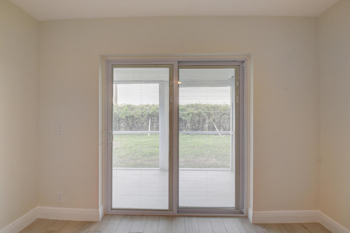 76 Flanders B Delray Beach, FL 33484 - Photo 17 of 35 a view of an empty room and window