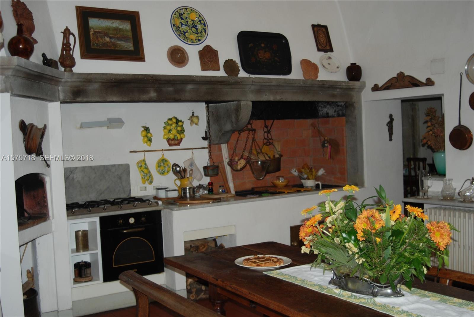 0 Unita Immobiliare In undefined, FL 0 - Photo 2 of 46 a kitchen with a stove and a table
