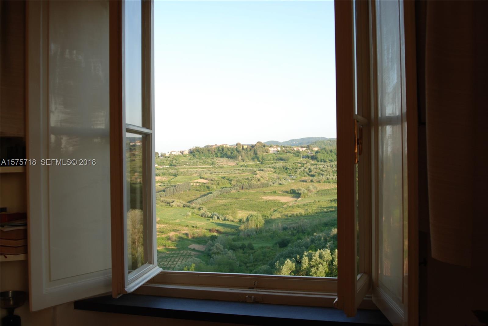 0 Unita Immobiliare In undefined, FL 0 - Photo 24 of 46 a view of a room with a large window and wooden floor