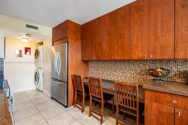 a kitchen with stainless steel appliances a refrigerator and a sink