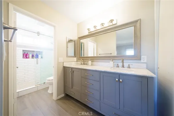 a bathroom with a double vanity sink and a mirror