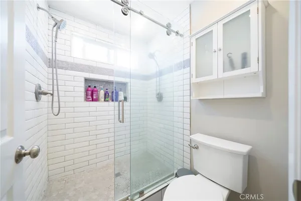 a bathroom with a toilet and a shower