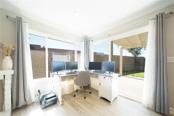 a workspace with furniture and a large window