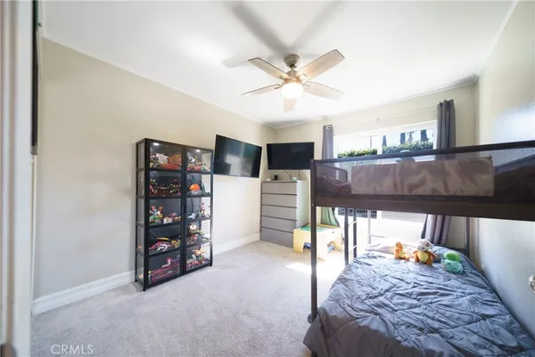 a bedroom with a bed and a book shelf