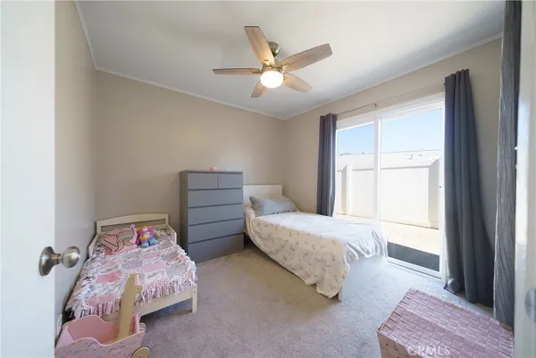 a bedroom with two beds and window