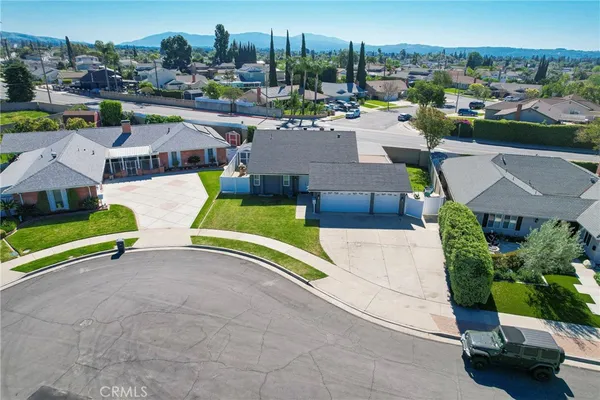 an aerial view of residential houses with yard