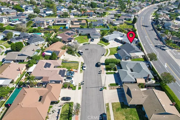 an aerial view of residential houses with outdoor space and street view