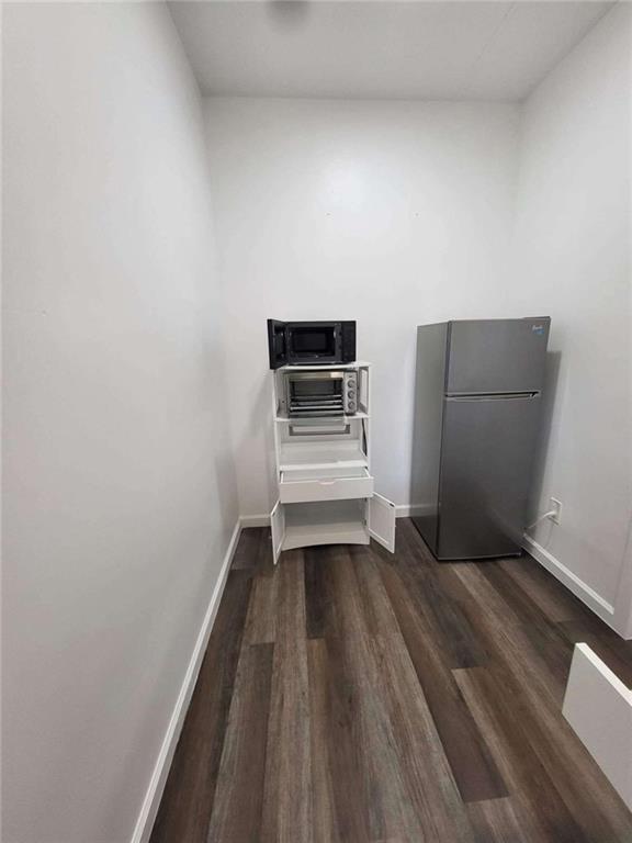 389 Collins Road Toccoa, GA 30577 - Photo 4 of 15 a view of a room with wooden floor and electronic appliances