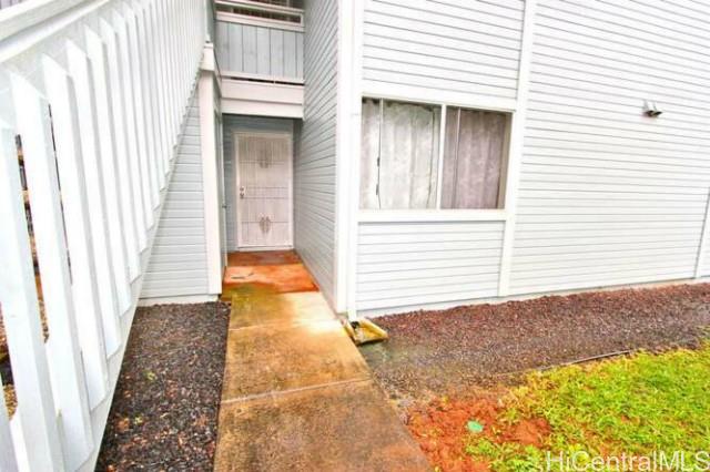 95-802 Wikao Street, Unit R102 Mililani, HI 96789 - Photo 1 of 1 a view of a house with a door and a window
