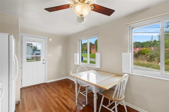 a view of a dining room with furniture window and wooden floor
