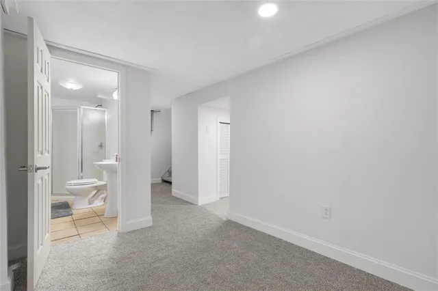 a bathroom with a toilet sink and shower