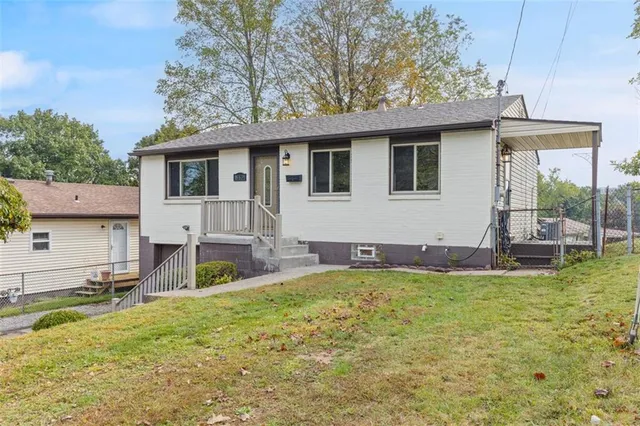 a view of a house with a yard patio and fire pit