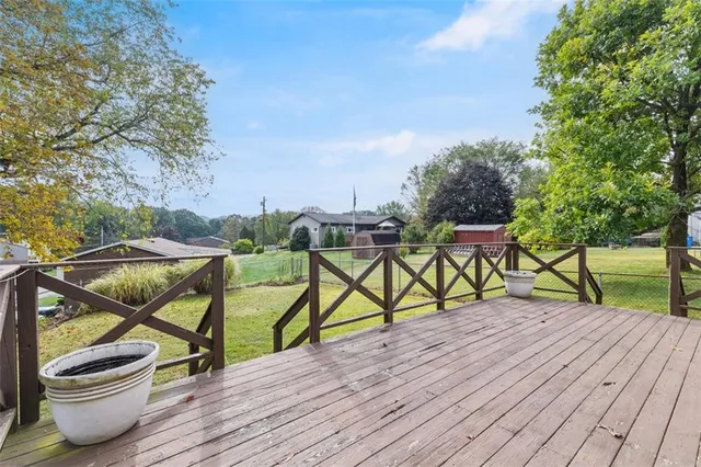 a balcony with wooden floor and outdoor seating
