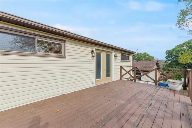 a view of a house with a big yard and large trees