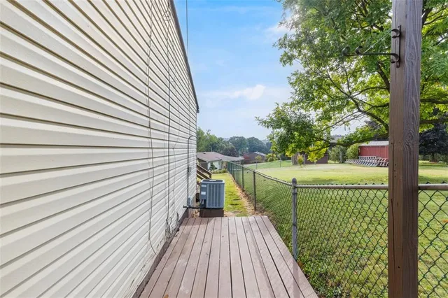 an aerial view of residential houses with outdoor space and swimming pool