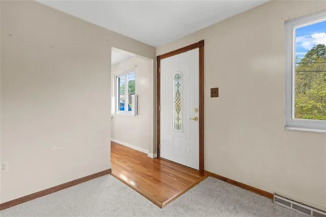 an empty room with windows and closet