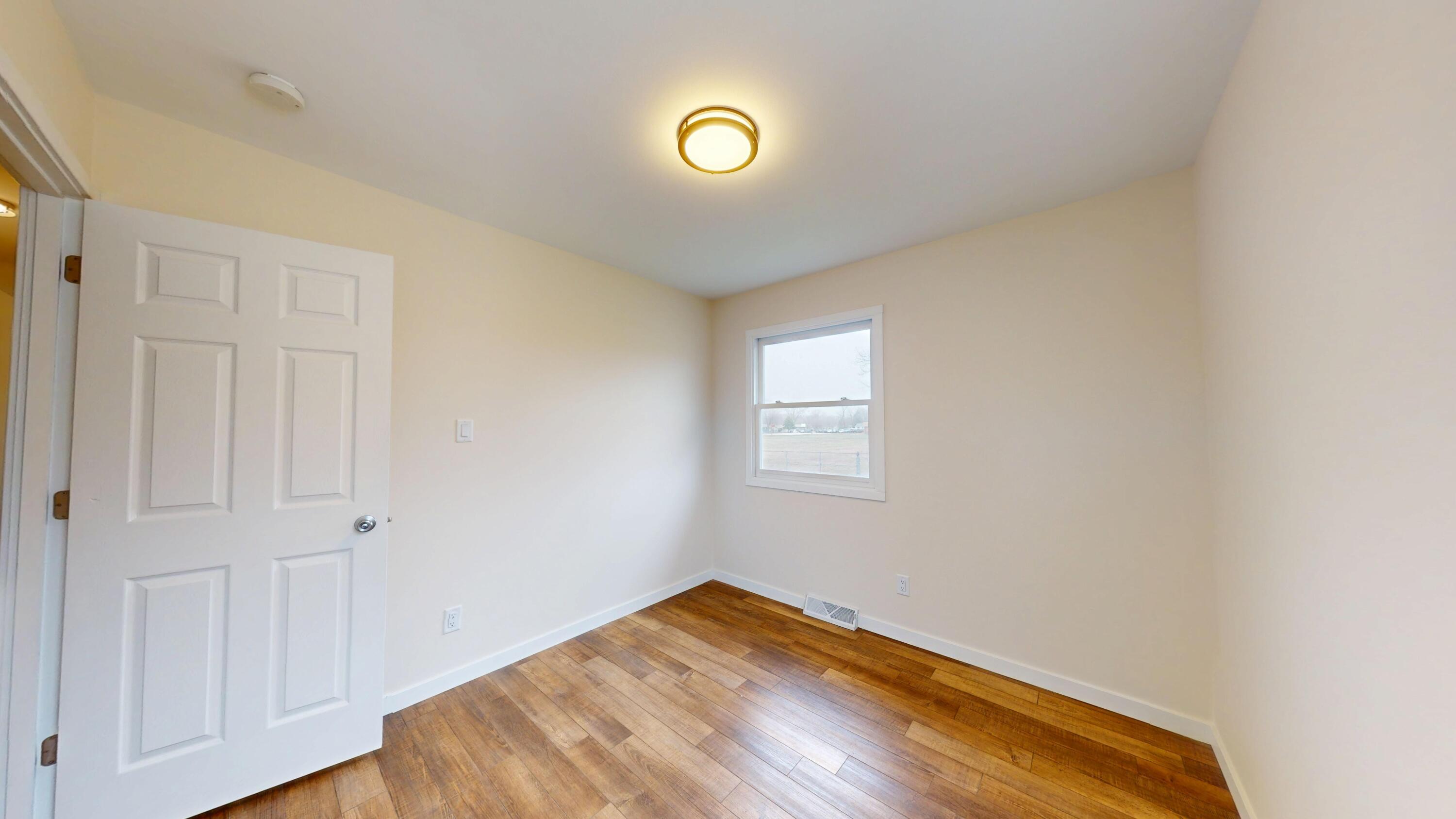 317 Redpath Avenue Michigan City, IN 46360 - Photo 12 of 40 a view of empty room with wooden floor