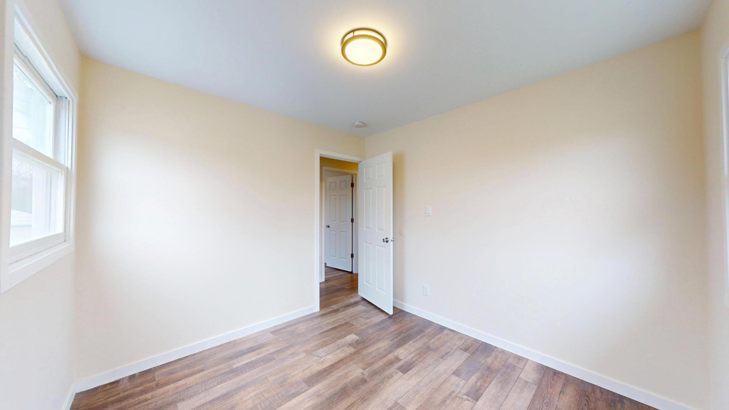 317 Redpath Avenue Michigan City, IN 46360 - Photo 13 of 40 a view of room with wooden floor