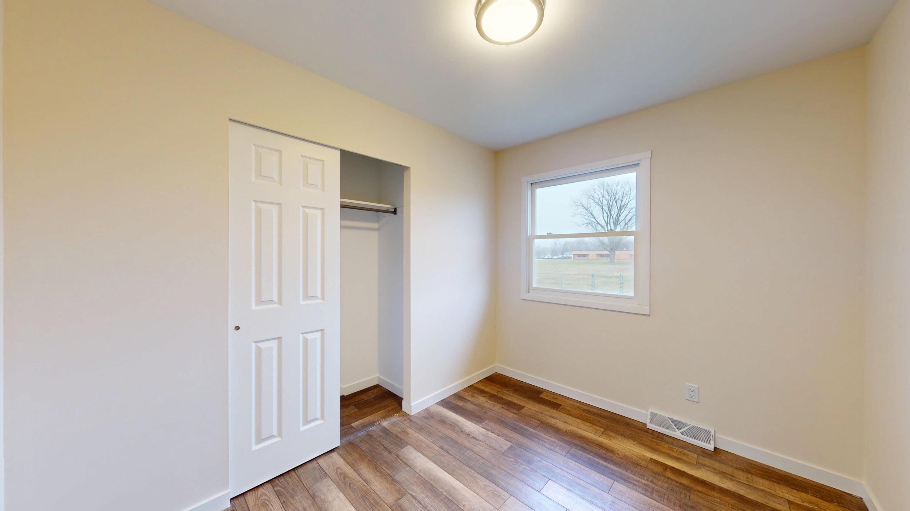 317 Redpath Avenue Michigan City, IN 46360 - Photo 15 of 40 a view of an empty room with closet and a window